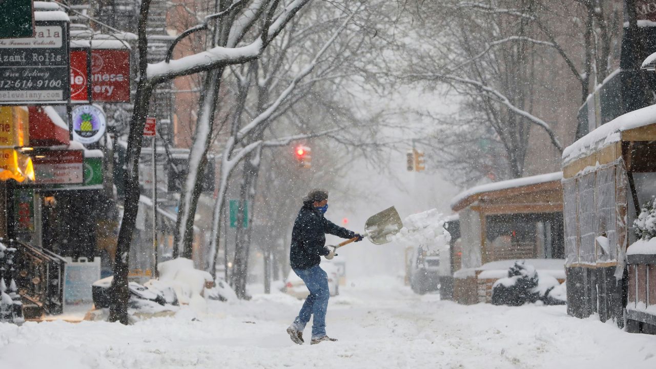 A person shovels snow in New York's Greenwich Village neighborhood on Monday.