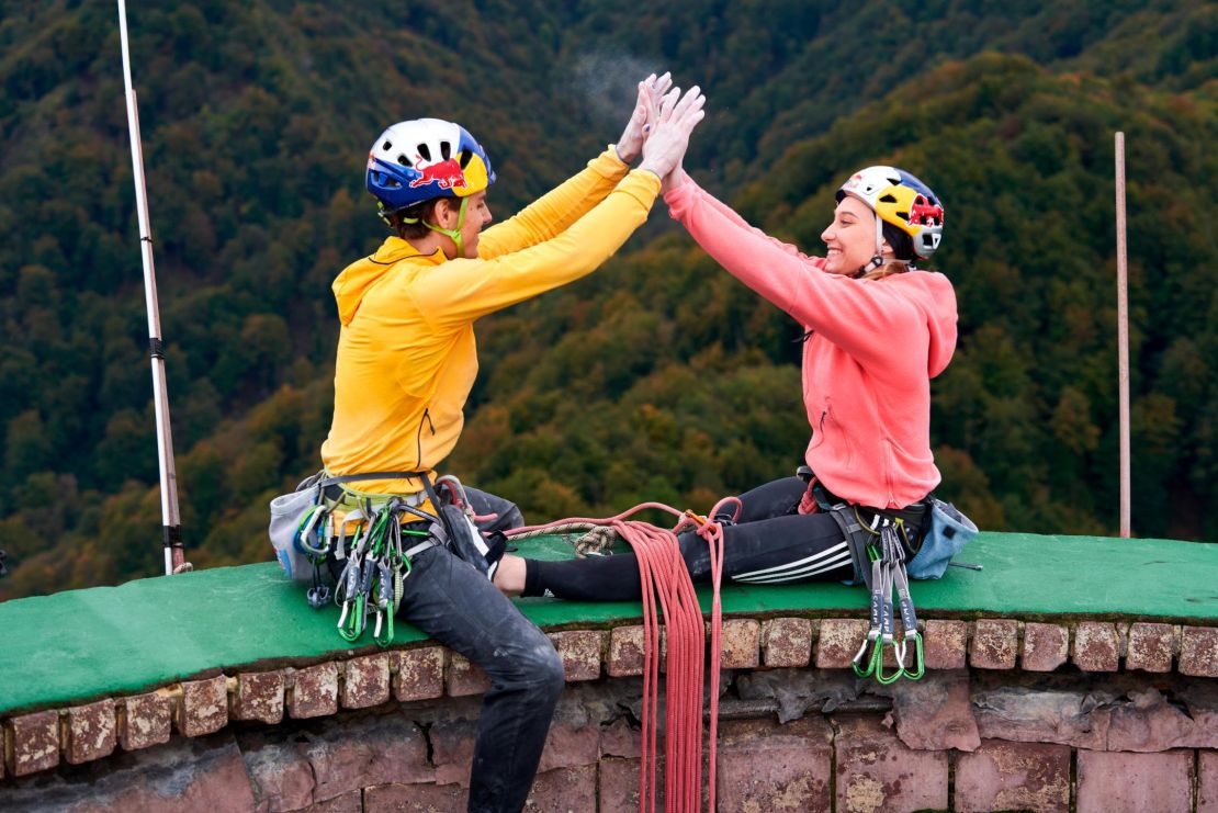 Janja Garnbret and Domen Škofic celebrate their ascent on top of the Trbovlje Chimney.