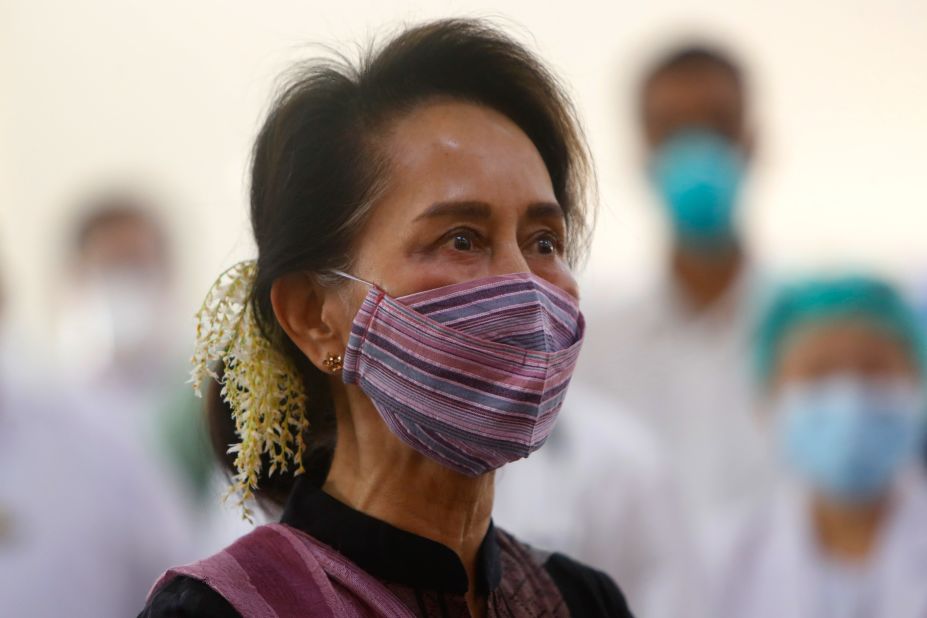 Suu Kyi watches the vaccination of health workers at a hospital in Naypyidaw in January 2021. A few days later, the military detained her in a coup.