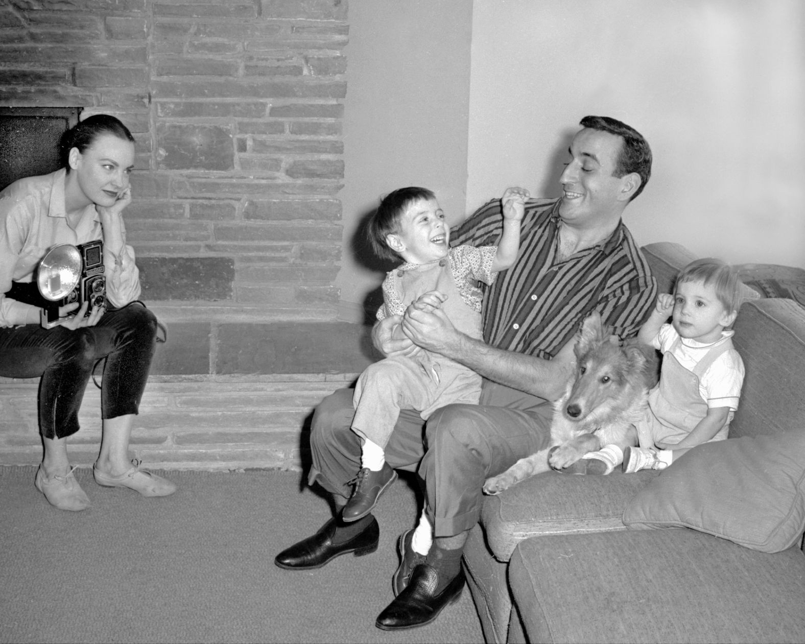 Bennett plays with his son D'Andrea next to his son Daegal and Pat the collie in 1957. His wife, Patricia, is on the left.