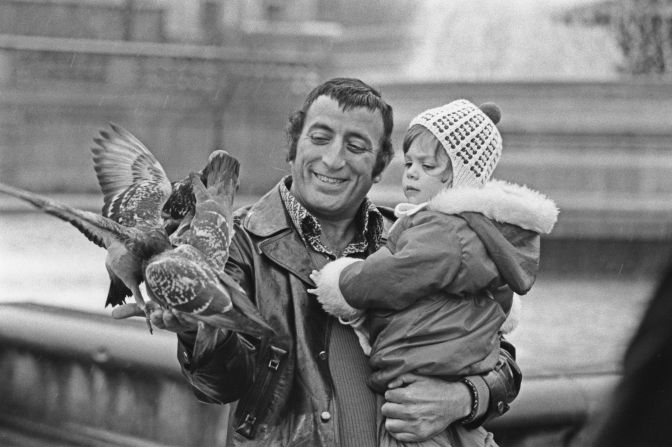 Bennett feeds pigeons with his daughter Joanna in 1972.