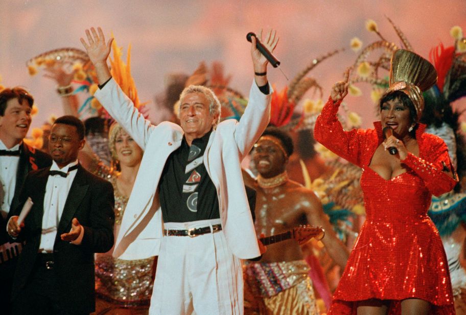Bennett, next to singer Patti LaBelle, entertain the crowd as part of the Super Bowl halftime show in 1995.