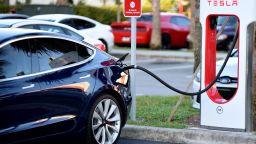 A Tesla electric car is seen parked at a charging station in Altamonte Springs, Florida on January 20, 2019.