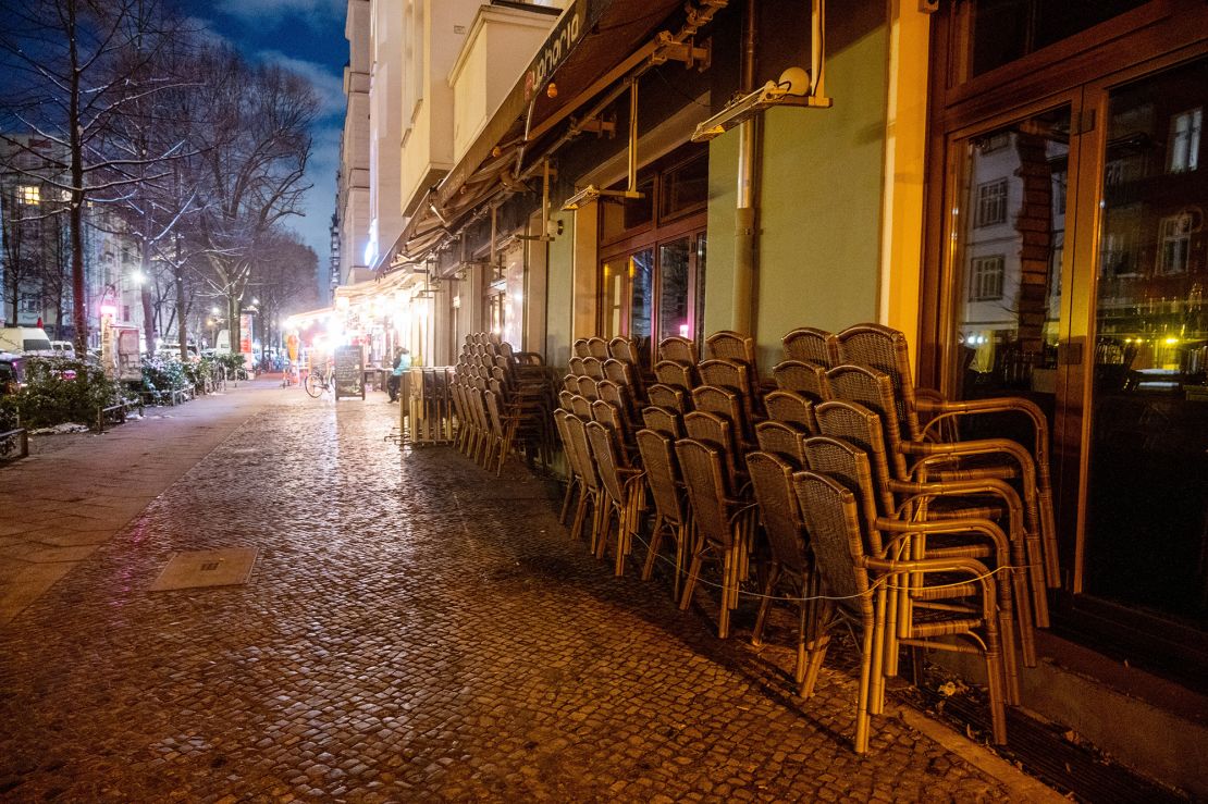 Chairs are piled on top of each other in front of a restaurant in Berlin on January 30.