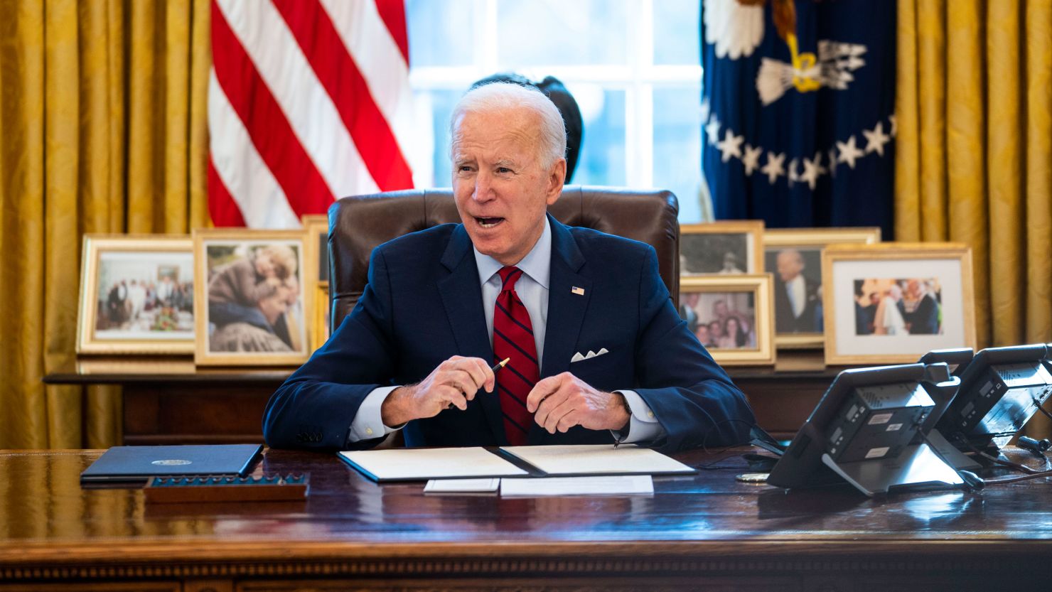 U.S. President Joe Biden signs executive actions in the Oval Office of the White House on January 28, 2021 in Washington, DC. Photo by Doug Mills-Pool/Getty Images