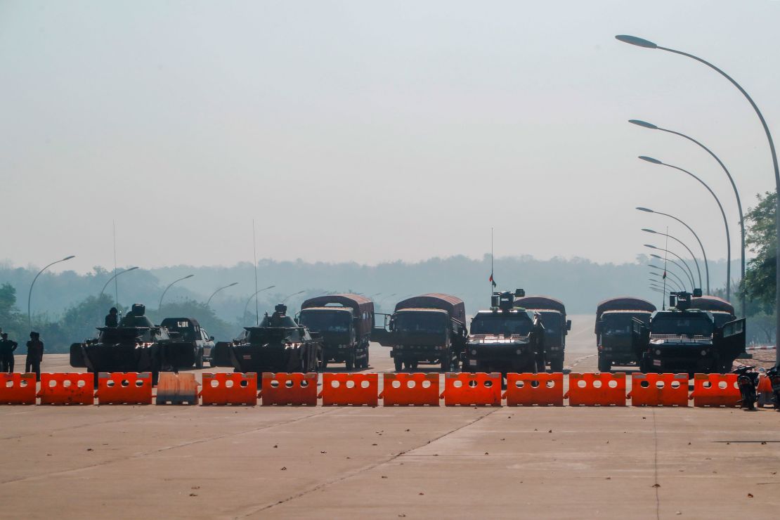 Myanmar's military stand guard at a checkpoint manned with armored vehicles blocking a road leading to the parliament building on Febuary 2, 2021, in Naypyidaw, Myanmar. 