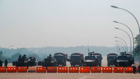 Myanmar's military stand guard at a checkpoint manned with armored vehicles blocking a road leading to the parliament building on Febuary 2, 2021, in Naypyidaw, Myanmar. 