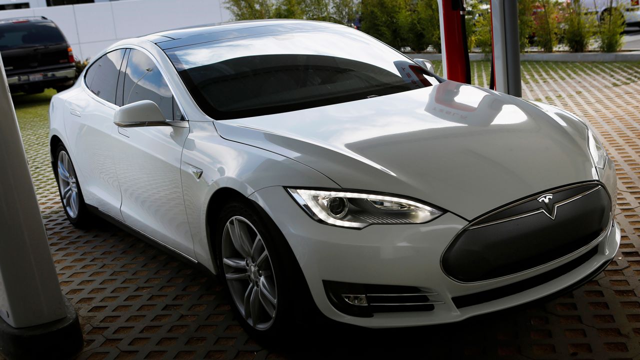 A Tesla Motors Inc. Model S vehicle is charged at company's design studio in Hawthorne, California, U.S., on Wednesday, July 31, 2013. The Tesla Model S led sales in the plug-in hybrid electric and electric vehicle market segments with an estimated 23.7% of the segments and 3.6% of the entire hybrid market. Photographer: Patrick T. Fallon/Bloomberg via Getty Images