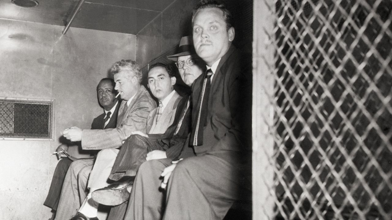 From left, Communist Party USA members Benjamin Davis Jr., Eugene Dennis, Gilbert Green, John Williamson and Gus Hall are transported to a jail cell in October 1949. 