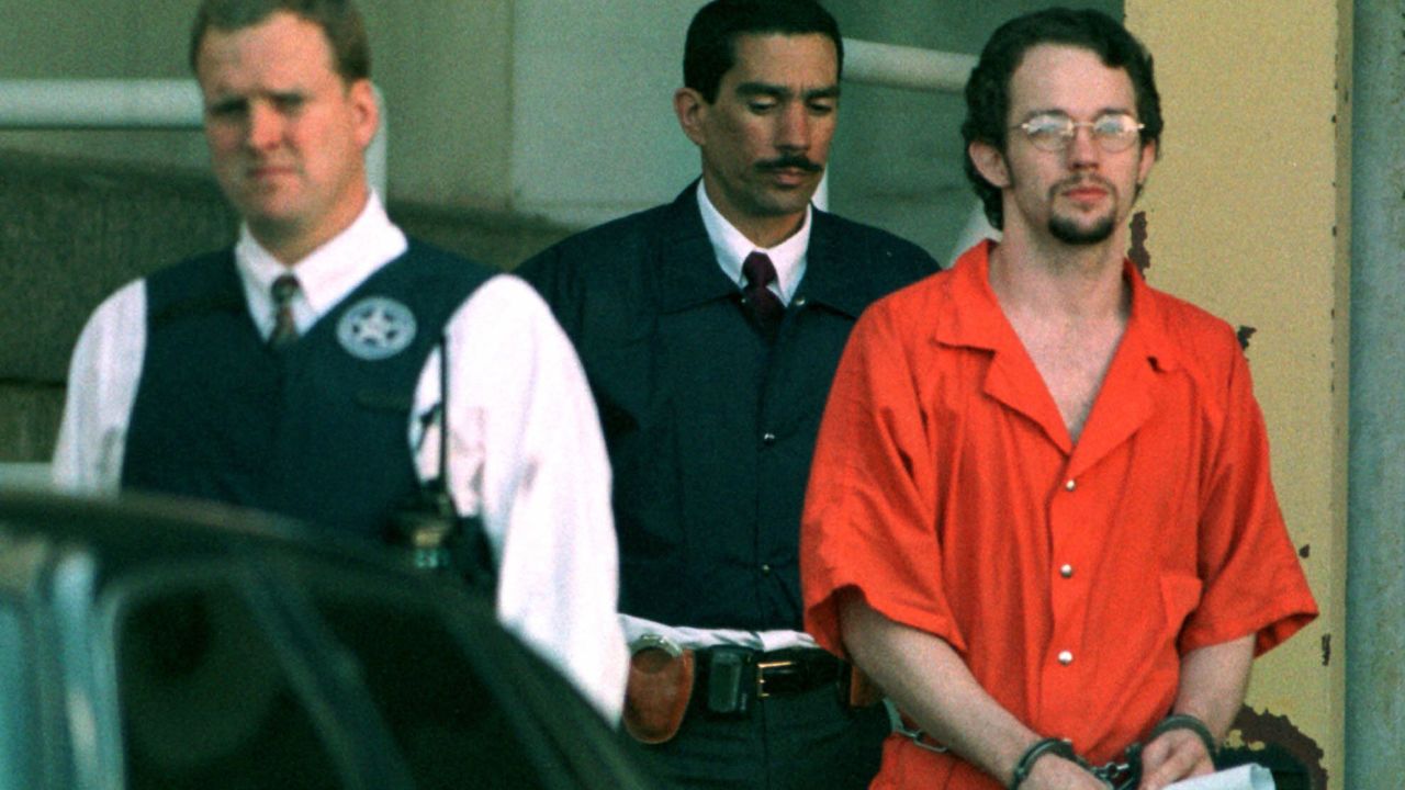 Officers escort Chevie Kehoe at a federal court building in Little Rock, Arkansas, in May 1999.