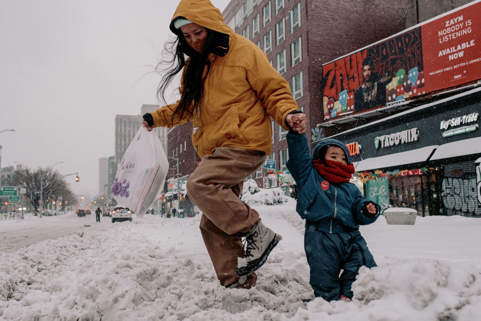 People walk through snow-covered streets in New York on Monday.
