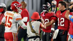 FILE- In this Nov. 29, 2020, file photo, Tampa Bay Buccaneers quarterback Tom Brady (12) congratulates Kansas City Chiefs quarterback Patrick Mahomes (15) after their NFL football game in Tampa, Fla. The Super Bowl matchup features the most accomplished quarterback ever to play the game who is still thriving at age 43 in Brady against the young gun who is rewriting record books at age 25.  (AP Photo/Jason Behnken, File)