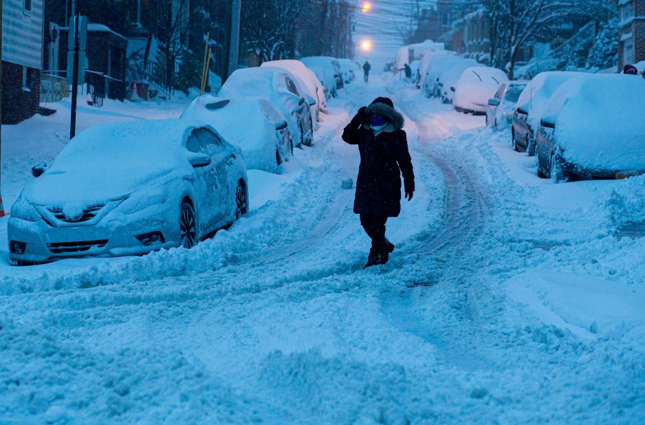 A woman walks on a snowy street in North Bergen, New Jersey, on Monday.