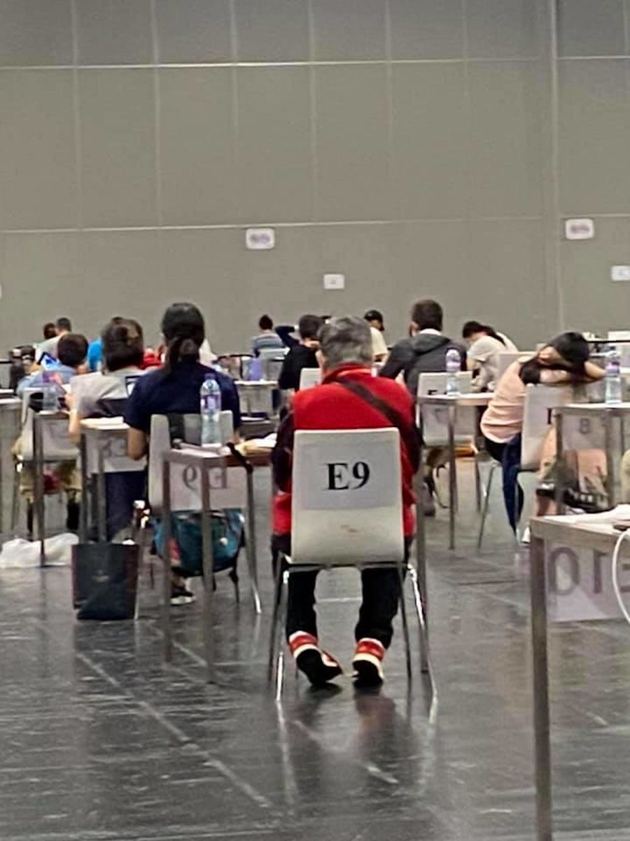 Anna Gong waits for her test results. Sharon Hawkins Leung, who took this photo, joked she had just tried to "make a run for it but the guards made her return to seat!"