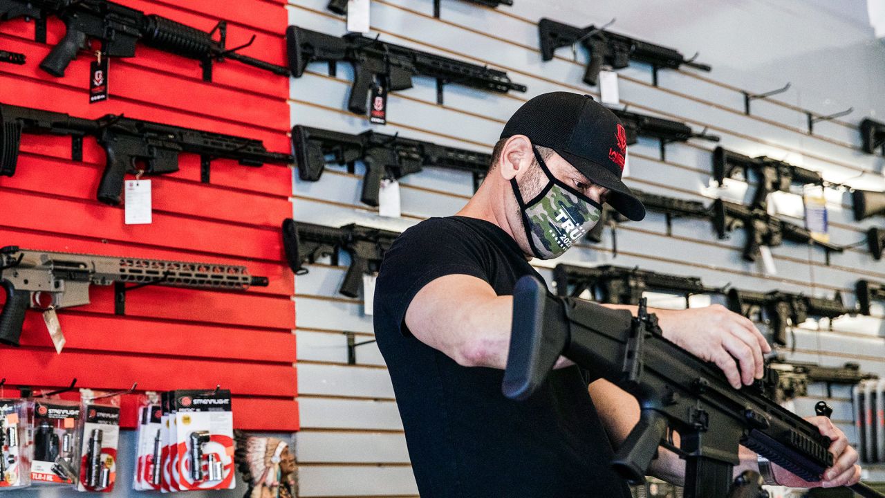 Wex Gunworks owner Brandon Wexler talks with a customer at his store in Delray Beach, Florida, on Oct. 15, 2020.