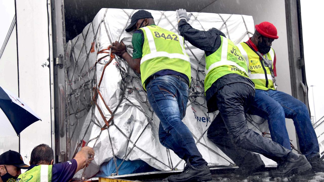 Workers load South Africa's first coronavirus  vaccine doses as they arrive at an airport in Johannesburg, South Africa, in this handout picture taken February 1, 2021.
