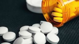 Medicines tablets and orange pill bottle, medications drugs, macro