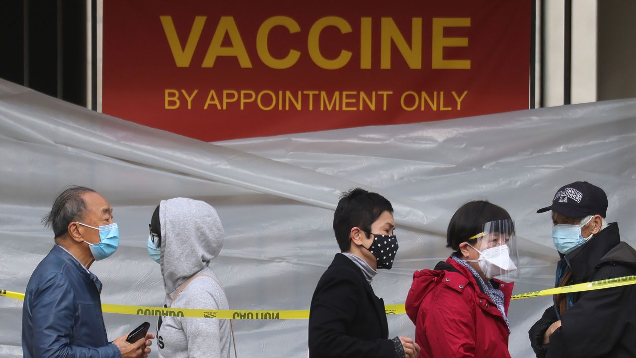 LOS ANGELES, CALIFORNIA - JANUARY 28: People with appointments stand in line to receive the COVID-19 vaccine at a vaccination site at Lincoln Park in East Los Angeles amid eased lockdown restrictions on January 28, 2021 in Los Angeles, California. The California Department of Public Health has announced an updated COVID-19 vaccine delivery plan as the state has faced mounting criticism over a slow coronavirus vaccine rollout. (Photo by Mario Tama/Getty Images)