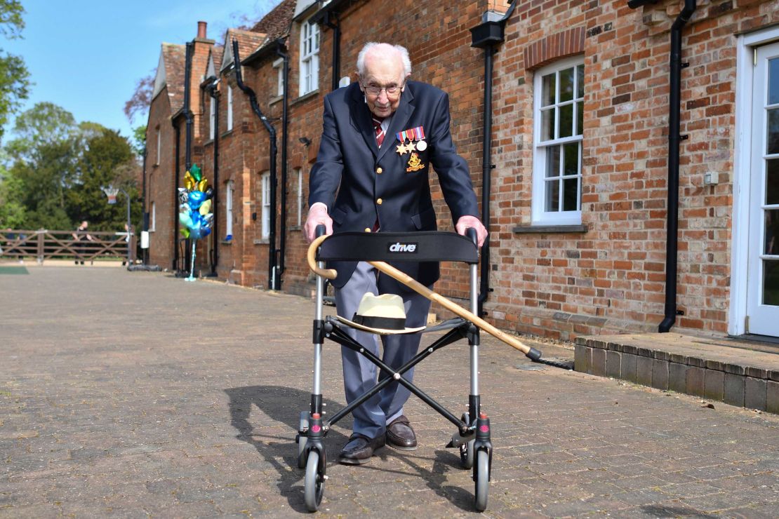 Captain Tom Moore poses with his walking frame while doing a lap of his garden on April 16, 2020.