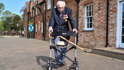 Captain Tom Moore poses with his walking frame while doing a lap of his garden on April 16, 2020.