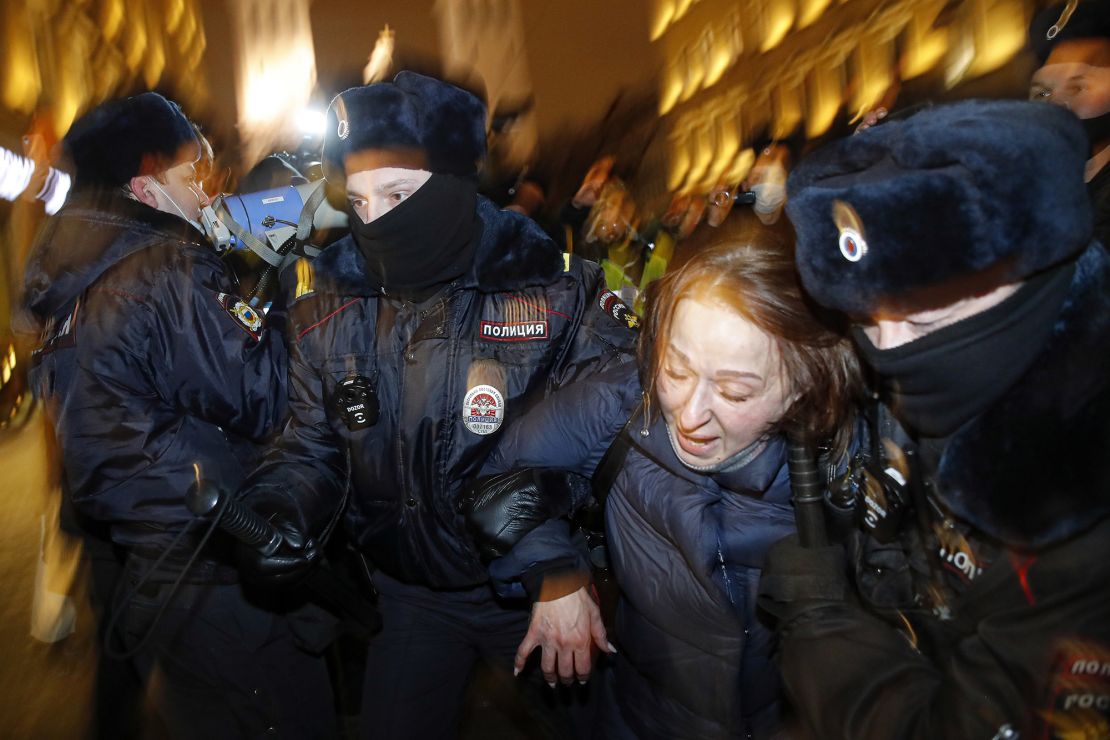 Police officers detain a Navalny supporter during a protest in St. Petersburg, Russia, on Tuesday.