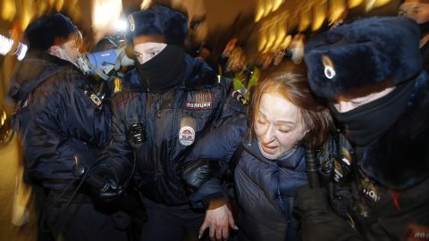 Police officers detain a Navalny supporter during a protest in St. Petersburg on Tuesday.
