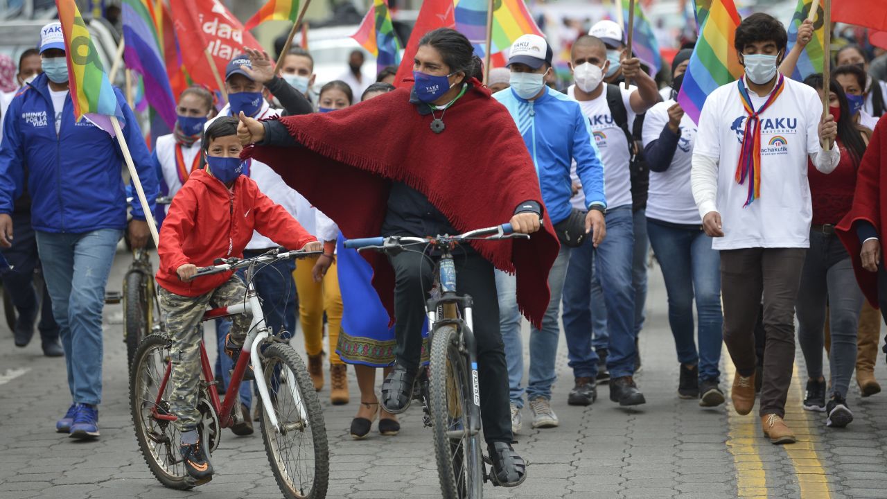 Pérez gives the thumbs up as he rides a bike during a campaign rally in Machachi, Ecuador, last month.