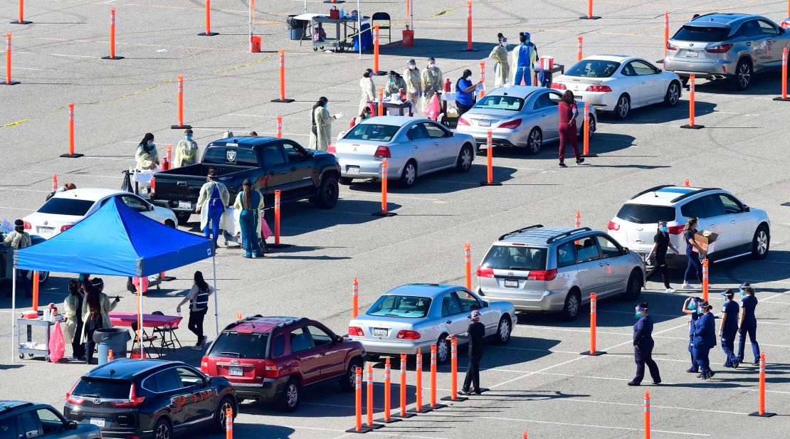 People arrive for their Covid-19 vaccine at the Auto Club Speedway in Fontana, California on February 2, 2021.