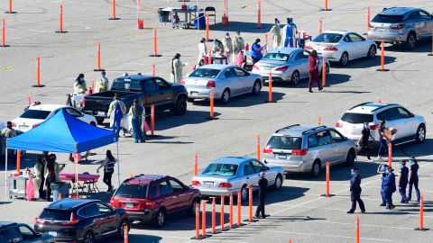 People arrive for their Covid-19 vaccine at the Auto Club Speedway in Fontana, California on February 2, 2021.