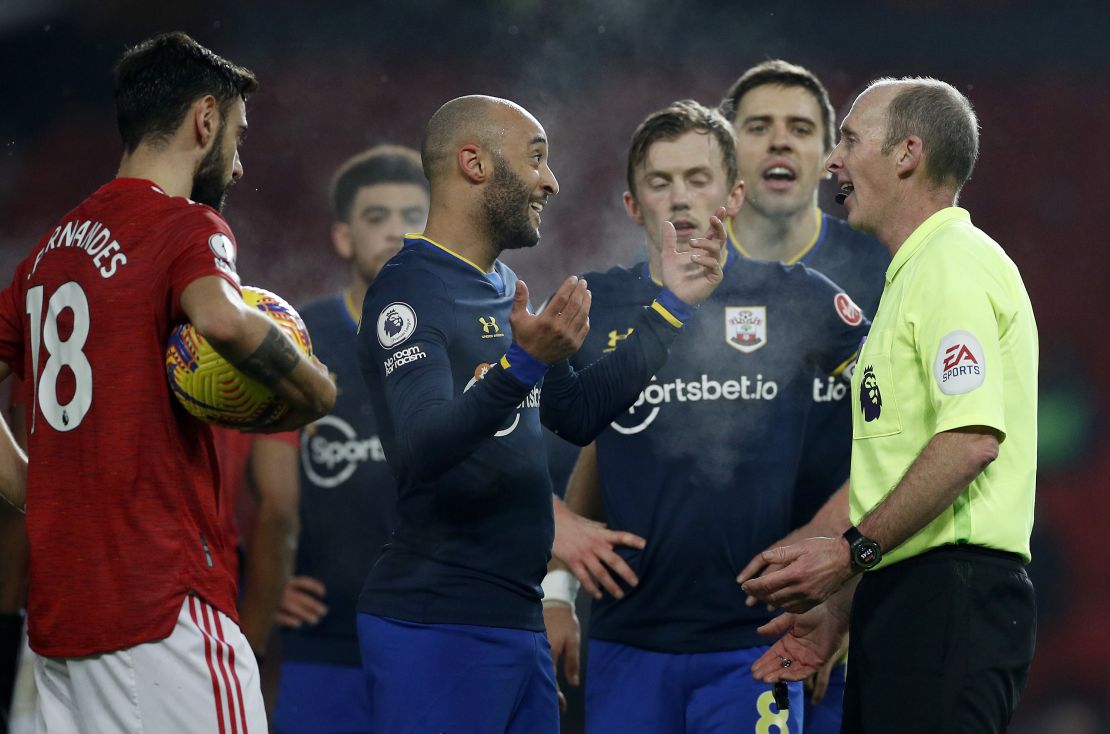 Southampton players remonstrate with referee Mike Dean after their side's second red card. 