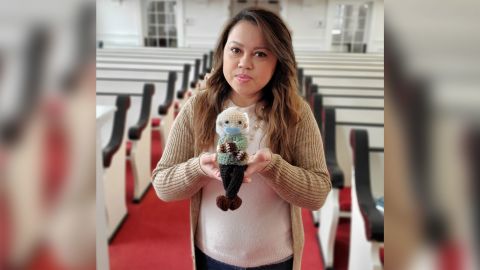 Chávez holds up the Bernie Sanders doll she crocheted.
