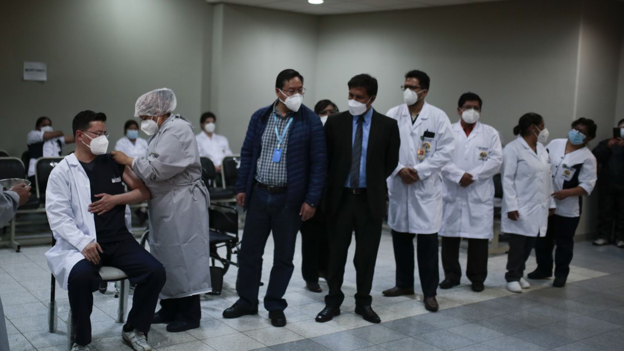 A nurse Injects the Sputnik V vaccine to the first doctor as part of the vaccination plan against COVID-19 at Hospital del Norte in El Alto, Bolivia. (Photo by Gaston Brito/Getty Images)