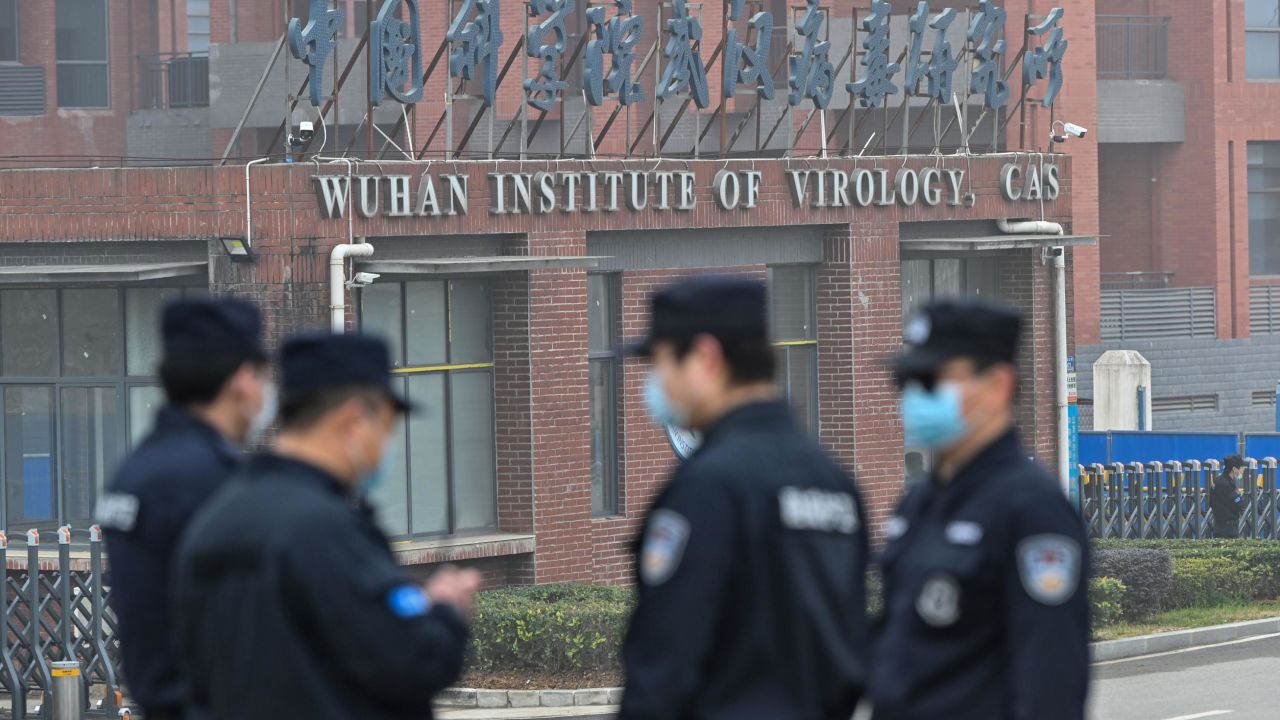 Security personnel stand guard outside the Wuhan Institute of Virology in Wuhan as members of the World Health Organization (WHO) team investigating the origins of the Covid-19 coronavirus make a visit to the institute in Wuhan in China's central Hubei province on February 3, 2021