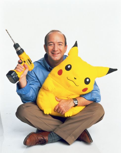 Bezos holds a power drill and a stuffed Pikachu in 1999. By this point, Amazon had started to sell items other than books.