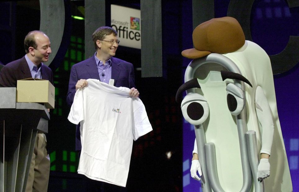 Bezos looks on as Microsoft CEO Bill Gates presents a T-shirt as a retirement gift to Clippy, the Microsoft Office assistant, in 2001. Microsoft was launching Office XP.