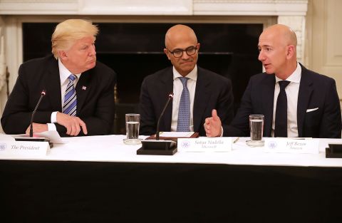 US President Donald Trump and Microsoft CEO Satya Nadella listen to Bezos at a White House meeting of the American Technology Council in 2017. According to the White House, the council's goal is "to explore how to transform and modernize government information technology."  