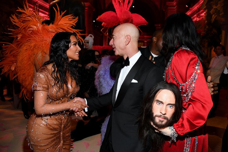 Bezos shakes hands with Kim Kardashian West while attending the Met Gala in New York in 2019. Actor Jared Leto is on the right.
