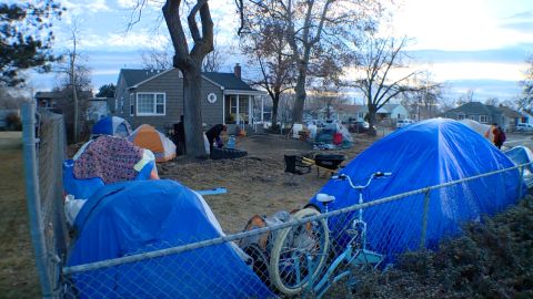 About 15 people live in tents in this suburban yard near Salt Lake City.