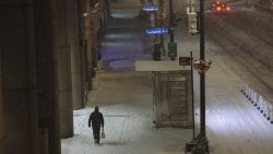A pedestrian walks along a street as snow falls in New York, U.S., on Wednesday, Dec. 16, 2020. Winter Storm Gail pounded the city as temperatures dropped to 27 degrees with frigid sustained winds up to 35 mph, making dining outdoors unbearable amid the Covid-19 pandemic that has already crippled the restaurant industry. Photographer: Angus Mordant/Bloomberg via Getty Images