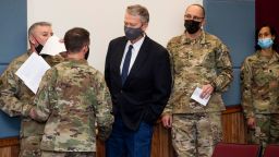 Idaho Gov. Brad Little is briefed before a news conference Wednesday, Feb. 3, 2021 with National Guard staff Maj. Gen. Michael Garshak, left, Col. Christopher Burt, and Lt. Col. Nicole Washington, right, at Gowen Field in Boise, Idaho, Wednesday, Feb. 3, 2021. Three Idaho Army National Guard pilots died Tuesday evening when their Black Hawk helicopter crashed near Boise during a training flight. (Darin Oswald/Idaho Statesman via AP)