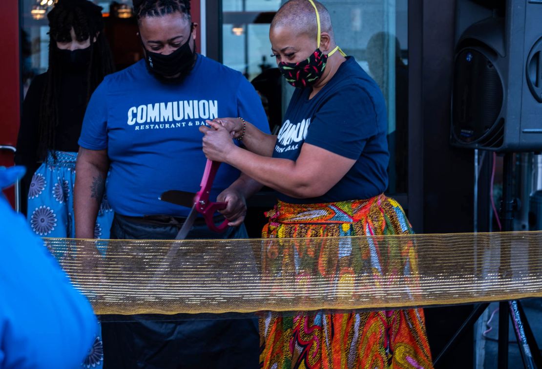 Damon Bomar (left) with his mother, Chef Kristi Brown, cut the ribbon to officially open their new Seattle restaurant, Communion, on December 5, 2020.