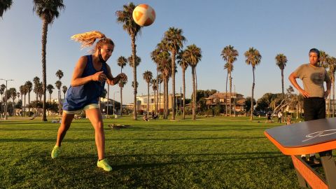 BellaTeq co-founder Carolyn Greco heads the ball in a Teqball game.