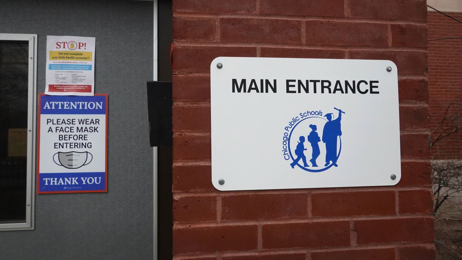 A sign outside of Columbus Elementary School encourages the use of face masks in Chicago, Illinois. 