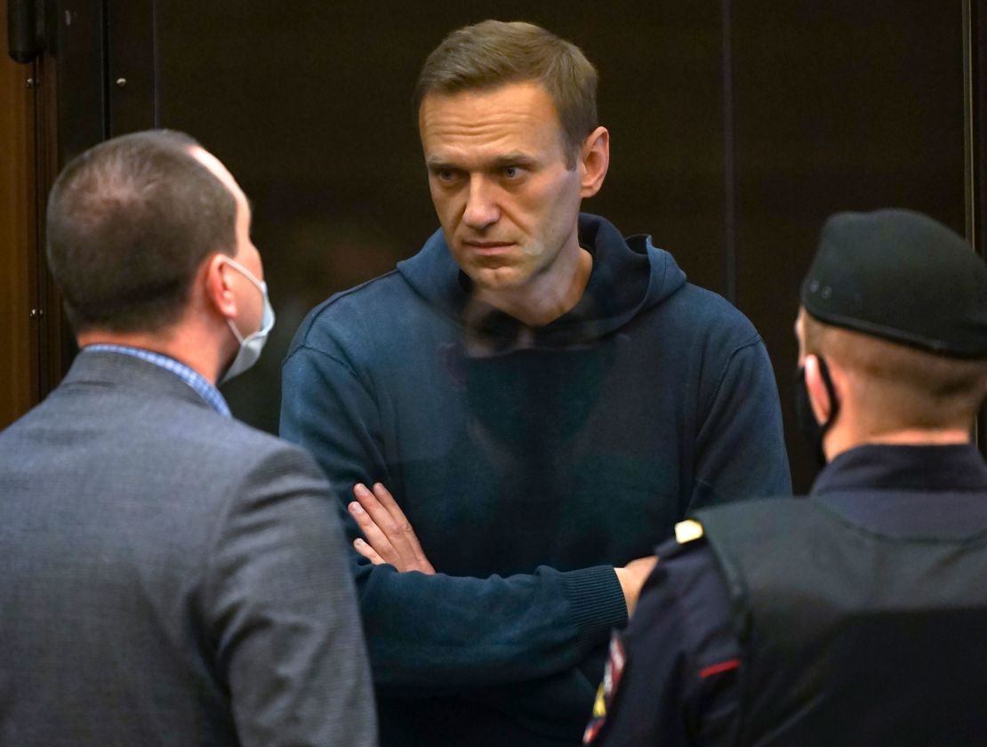 Russian opposition leader Alexei Navalny talks to one of his lawyers, left, while standing in a glass box during his hearing on Tuesday. 
