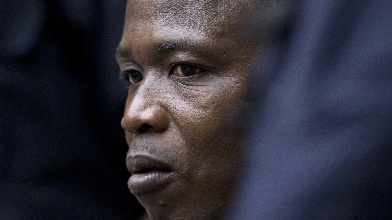 Dominic Ongwen, a senior commander in Uganda's Lord's Resistance Army (LRA), looks on at the International Criminal Court (ICC) in The Hague, on December 6, 2016. - Former child soldier-turned-warlord Dominic Ongwen becomes the first member of Uganda's brutal Lord's Resistance Army to go on trial in a landmark case before the International Criminal Court keenly watched by thousands of victims.