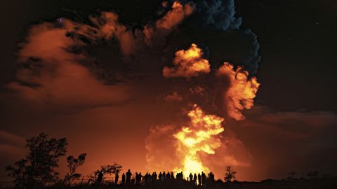 People watch as Kilauea volcano erupts on  December 20, 2020. 
