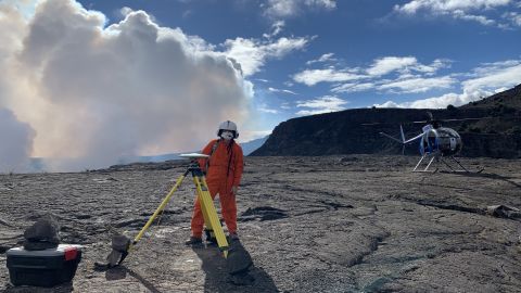 A Hawaiian Volcano Observatory geophysicist deploys technology on December 21, 2020, to measure changes in ground motion. 