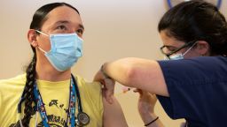 Colleen DAmico, a clinical pharmacist with the Seattle Indian Health Board, administers a Covid-19 vaccine to nurse Shawn Thurman on December 21, 2020.