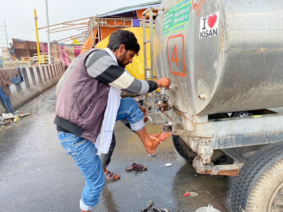 A farmer at the Ghazipur protest camp washes his leg, on February 4, 2021.