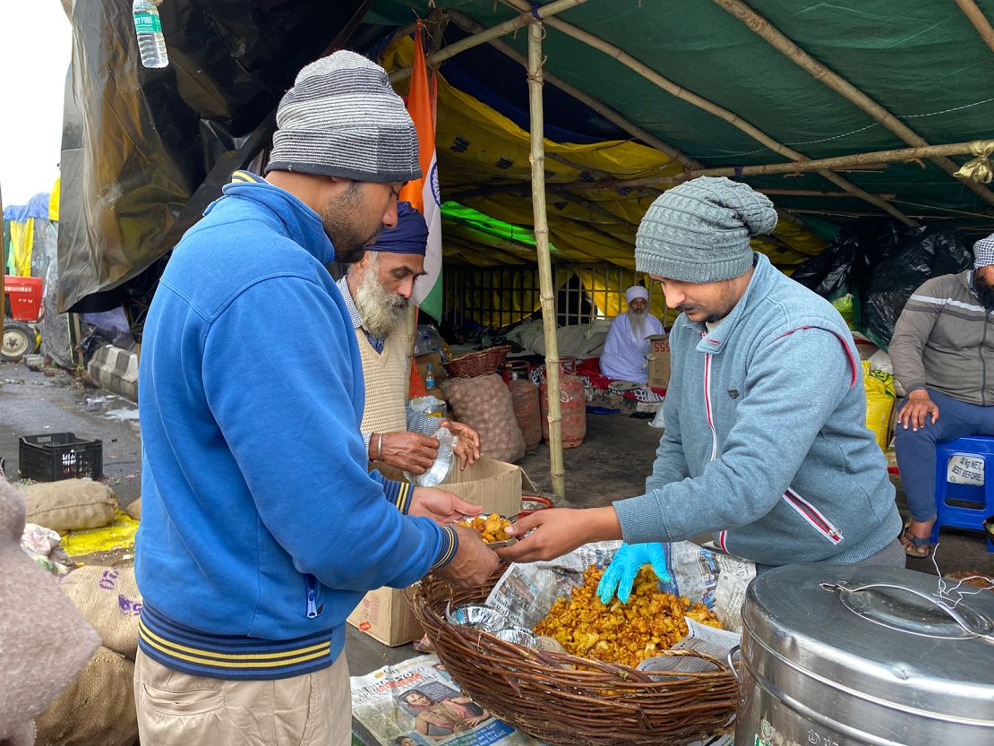 A farmer gives out food at the camp in Ghazipur, on February 4, 2021.